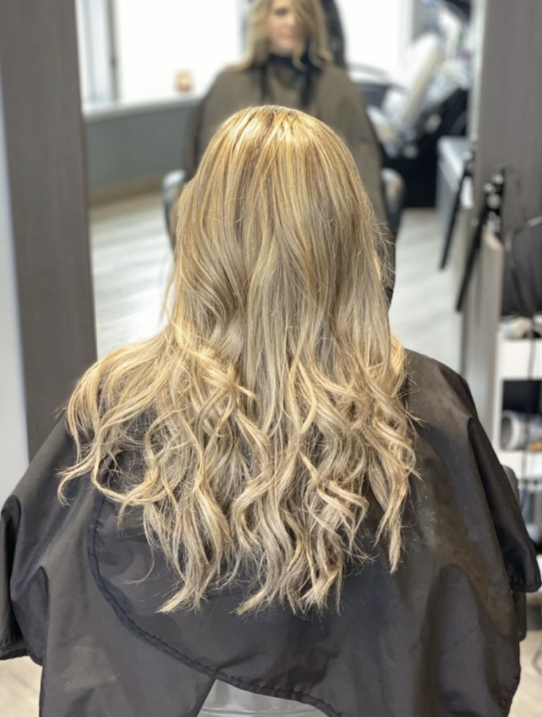 Expertly blond dyed hair shows Ayda Ghaffari's skill at cutting and coloring. The blowout demonstrates her detail-oriented approach.